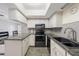 Contemporary kitchen featuring granite countertops, stainless steel appliances, and a bright atmosphere at 5428 Larchmont N Ct # 5428, Pinellas Park, FL 33782