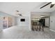 Open floor plan showcasing the living room, kitchen, modern flooring, and access to the patio at 5428 Larchmont N Ct # 5428, Pinellas Park, FL 33782