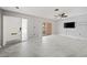 Bright living room with gray walls, modern flooring, ceiling fan, and sliding glass doors at 5428 Larchmont N Ct # 5428, Pinellas Park, FL 33782
