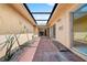 Open-air patio has room for plants and decorations, and doors leading into the home at 5428 Larchmont N Ct # 5428, Pinellas Park, FL 33782