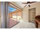 The sunroom has a sliding glass door and a view of the tiled patio, and a closet with shelving at 5428 Larchmont N Ct # 5428, Pinellas Park, FL 33782