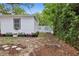 Landscaped backyard featuring flower boxes and stepping stones with white fencing at 559 Scotland St, Dunedin, FL 34698