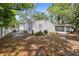 Backyard featuring a patio area, mature trees, and a screened-in porch at 559 Scotland St, Dunedin, FL 34698