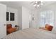 Bright bedroom featuring stylish lighting, decor, and a view into an en-suite bathroom at 559 Scotland St, Dunedin, FL 34698