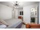 Bright bedroom featuring stylish lighting, decor, and a view into an en-suite bathroom at 559 Scotland St, Dunedin, FL 34698