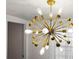 Striking chandelier adds modern elegance to this room with ample natural light and tasteful decor at 559 Scotland St, Dunedin, FL 34698