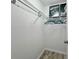 Walk-in closet with shelving and rod for storage, featuring car-themed art at 559 Scotland St, Dunedin, FL 34698