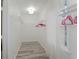 Bright, organized walk-in closet featuring white wire shelving and light wood-look floors at 559 Scotland St, Dunedin, FL 34698