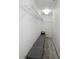 Clean, walk-in closet featuring white wire shelving and light wood-look floors for storage at 559 Scotland St, Dunedin, FL 34698