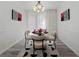 Bright dining area boasts modern lighting and sleek flooring, creating an inviting atmosphere for meals and gatherings at 559 Scotland St, Dunedin, FL 34698