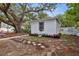 Charming exterior view of the home with well-maintained landscaping and mature trees offering shade at 559 Scotland St, Dunedin, FL 34698