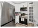 Kitchen featuring stainless steel appliances, white cabinetry, and modern backsplash at 559 Scotland St, Dunedin, FL 34698