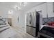 Bright kitchen with stainless steel refrigerator, quartz countertops and modern design at 559 Scotland St, Dunedin, FL 34698