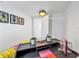 Bright office space featuring a dark desk with bright yellow accents, modern lighting, and stylish decor at 559 Scotland St, Dunedin, FL 34698