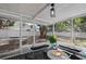 Enclosed porch with outdoor seating and a view of a fenced backyard at 559 Scotland St, Dunedin, FL 34698