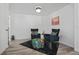 Sitting room featuring two comfortable armchairs, and colorful pillows and ottoman at 559 Scotland St, Dunedin, FL 34698
