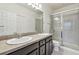 Double sink vanity with a glass door shower and toilet at 5619 Tranquil Pond Pl, Riverview, FL 33578
