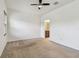 Large bedroom featuring a ceiling fan and adjoined bathroom at 5619 Tranquil Pond Pl, Riverview, FL 33578