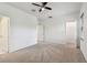Spacious, carpeted bedroom with ceiling fan and a view into the closet at 5619 Tranquil Pond Pl, Riverview, FL 33578