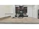Kitchen island and dark cabinetry, with tiled backsplash and stainless appliances at 5619 Tranquil Pond Pl, Riverview, FL 33578