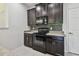 Well-equipped kitchen featuring dark cabinetry, sleek appliances, and a stylish backsplash at 5619 Tranquil Pond Pl, Riverview, FL 33578