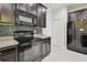 Kitchen with dark cabinets, tiled backsplash, and stainless steel appliances at 5619 Tranquil Pond Pl, Riverview, FL 33578