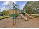 Community playground featuring slides and climbing apparatus surrounded by lush greenery, creating a safe and enjoyable play area at 5619 Tranquil Pond Pl, Riverview, FL 33578