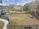 Overhead view featuring playground and dog park in fenced green space with walking path, offering recreation for the whole Gathering at 5619 Tranquil Pond Pl, Riverview, FL 33578