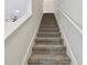 A long staircase leads to the upper level of this home at 5619 Tranquil Pond Pl, Riverview, FL 33578