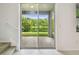 Sliding glass doors reveal tranquil water views from the rear patio of this home at 5619 Tranquil Pond Pl, Riverview, FL 33578
