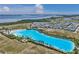 Aerial view of community's expansive pool, coastline, and modern homes in a well-planned community at 6023 Cat Claw Ln, Bradenton, FL 34210