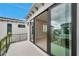A covered outdoor balcony featuring black railings and a sliding glass door to the interior at 6023 Cat Claw Ln, Bradenton, FL 34210