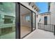 View from balcony looking into modern home with black framed windows and shutters at 6023 Cat Claw Ln, Bradenton, FL 34210