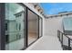 View from balcony overlooking modern home with black framed windows and shutters at 6023 Cat Claw Ln, Bradenton, FL 34210