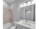 Elegant bathroom featuring a bath/shower combo, tiled walls, and modern vanity with faucet at 6023 Cat Claw Ln, Bradenton, FL 34210
