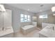 A bright, modern bathroom features double sinks, a soaking tub, and a glass-enclosed shower at 6023 Cat Claw Ln, Bradenton, FL 34210
