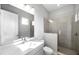 Modern bathroom featuring glass enclosed shower, large mirror, and neutral color scheme at 6023 Cat Claw Ln, Bradenton, FL 34210