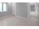 Bright bedroom featuring neutral paint and base trim with tiled flooring and white door at 6023 Cat Claw Ln, Bradenton, FL 34210