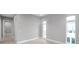 Bright bedroom with 3 large windows, tile flooring, and neutral color scheme at 6023 Cat Claw Ln, Bradenton, FL 34210