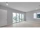 Neutral bedroom with tile flooring and natural light with access to a private balcony at 6023 Cat Claw Ln, Bradenton, FL 34210