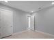 Contemporary bedroom featuring neutral colored walls, white trim, tiled flooring, and two white doors at 6023 Cat Claw Ln, Bradenton, FL 34210