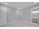 Modern bedroom with neutral colored walls, recessed lighting and tiled flooring leading to ensuite bathroom at 6023 Cat Claw Ln, Bradenton, FL 34210
