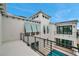 Stunning white modern home with black framed windows and shutters overlooking a pool area at 6023 Cat Claw Ln, Bradenton, FL 34210