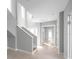 Bright foyer with tile floors, staircase and ample natural light from tall windows at 6023 Cat Claw Ln, Bradenton, FL 34210