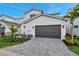 Spacious two car garage and paved driveway with manicured landscaping along the perimeter at 6023 Cat Claw Ln, Bradenton, FL 34210