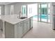 Kitchen island with sink, stainless appliances, and view to outdoor pool at 6023 Cat Claw Ln, Bradenton, FL 34210