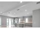Bright, modern kitchen features an island, recessed lighting, tile backsplash and stainless steel appliances at 6023 Cat Claw Ln, Bradenton, FL 34210