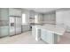 Bright kitchen with a center island, stainless steel appliances, and gray cabinets at 6023 Cat Claw Ln, Bradenton, FL 34210
