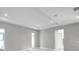 Spacious living room showcasing a tray ceiling, recessed lighting, and neutral wall color at 6023 Cat Claw Ln, Bradenton, FL 34210