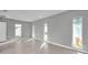 Light-filled living room with tile flooring, multiple windows, and recessed lighting at 6023 Cat Claw Ln, Bradenton, FL 34210